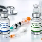 Two influenza vaccine vials labeled trivalent and quadrivalent flu vaccines placed on a medical table with syringes, cotton balls, and clinical equipment.